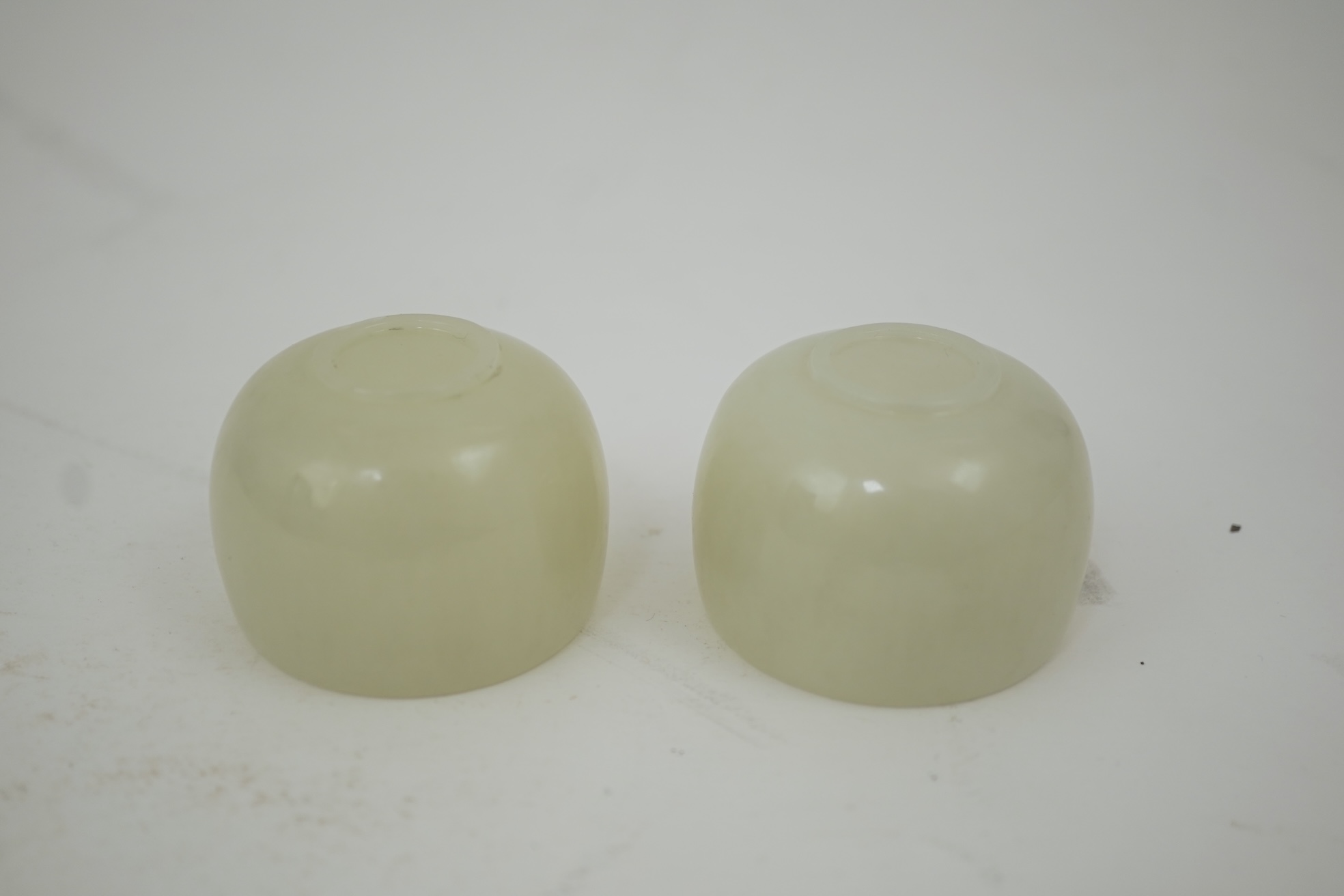 A pair of Chinese white jade cups, Qing dynasty or later